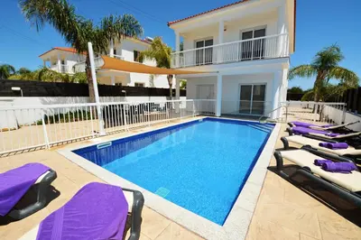 a swimming pool in front of a villa at Nissi Villa Christa in Ayia Napa