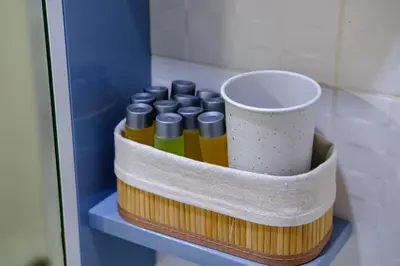 a shelf with a bunch of oils and a cup at Lazuli Sea View Beachfront Ap 254 in Larnaka