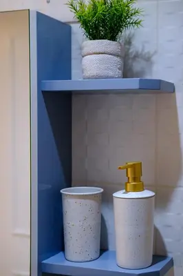 a shelf with two cups and a plant on it at Lazuli Sea View Beachfront Ap 254 in Larnaka