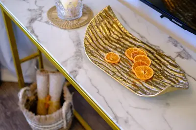 two slices of oranges on a gold plate on a counter at Lazuli Sea View Beachfront Ap 254 in Larnaka