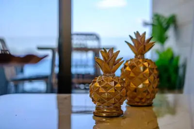 two pineapple vases sitting on top of a table at Lazuli Sea View Beachfront Ap 254 in Larnaka