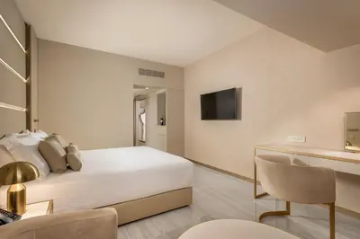 a hotel room with a bed and a television at Amarande (Adults Only) in Ayia Napa