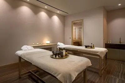 a therapy room with three beds and a mirror at Amarande (Adults Only) in Ayia Napa