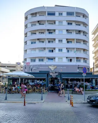 a large white building with people sitting in front of it at Lazuli Sea View Beachfront Ap 43 in Larnaka