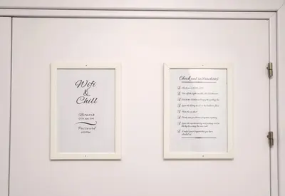 two framed pictures on a wall with a wedding menu at Lazuli Sea View Beachfront Ap 21 in Larnaka