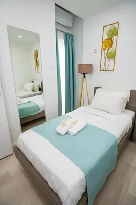 a bedroom with a bed with two towels on it at Lazuli Sea View Beachfront Ap 21 in Larnaka