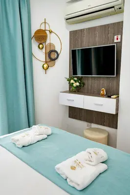 two towels on a bed in a room with a tv at Lazuli Sea View Beachfront Ap 21 in Larnaka