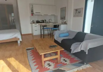 a living room with a couch and a table at Studio Room Ensuite by the Beach, Entire Independent Unit in Limassol