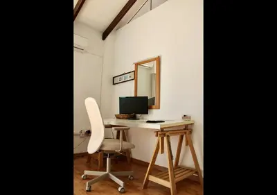 a desk with a computer and a chair in a room at Studio Room Ensuite by the Beach, Entire Independent Unit in Limassol