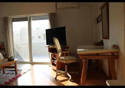 an office with a desk with a computer and a chair at Studio Room Ensuite by the Beach, Entire Independent Unit in Limassol