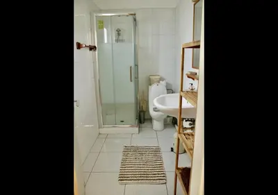 a bathroom with a shower and a sink and a toilet at Studio Room Ensuite by the Beach, Entire Independent Unit in Limassol