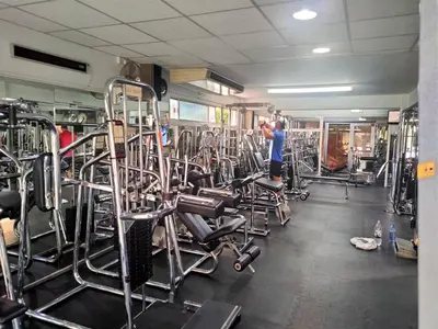 a man in a gym with a lot of equipment at Almond Business Hotel in Nicosia