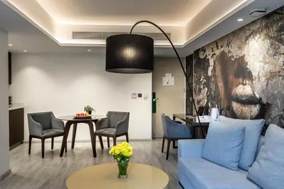 a living room with a blue couch and a table at Almond Business Hotel in Nicosia