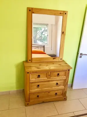 a mirror on top of a dresser in a room at Andreas Apartment in Limassol