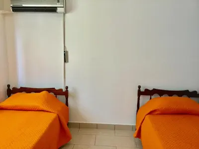 two beds sitting next to each other in a room at Andreas Apartment in Limassol