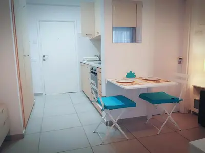 a small kitchen with a table and two chairs at Billis Beach Apartment in Limassol