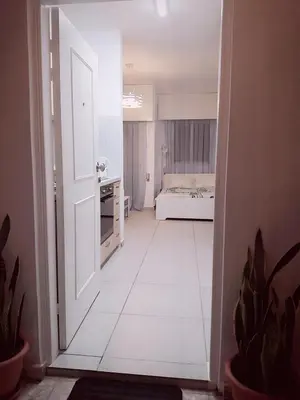 an open door to a room with a bedroom at Billis Beach Apartment in Limassol