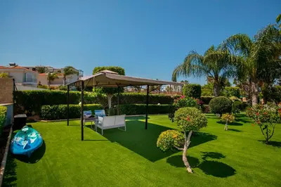 a garden with a gazebo and a lawn at Villa Ricky in Protaras