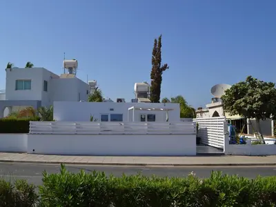 a white house with observatories on the side of it at Makronissos Beach Studio in Ayia Napa