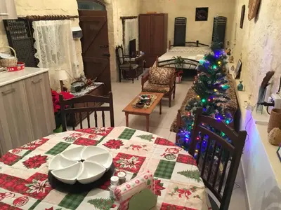 a room with a table with a christmas tree in it at Amalia Panorama House in Zanaja