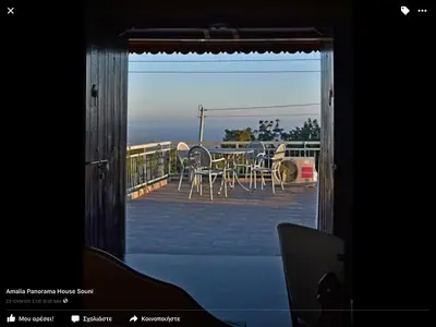 a door leading to a patio with a table and chairs at Amalia Panorama House in Zanaja