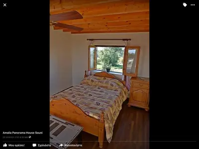 a bedroom with a bed and a dresser and a window at Amalia Panorama House in Zanaja