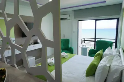 a bedroom with a bed with a view of the ocean at Lazuli Sea View-Beachfront Ap 405 in Larnaka