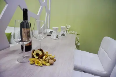 a table with a bottle of wine and two glasses at Lazuli Sea View-Beachfront Ap 405 in Larnaka