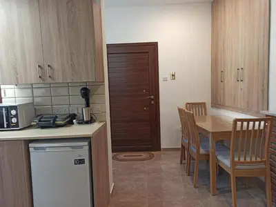 a kitchen with a table and chairs and a kitchen with a refrigerator at River Apartments in Galata
