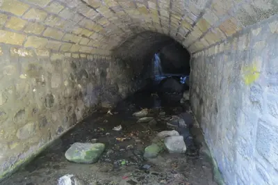 a tunnel with a pile of trash in it at River Apartments in Galata