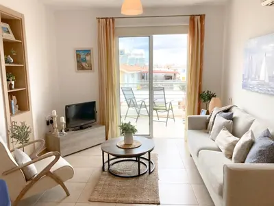 a living room with a couch and a tv at Apartment Helena in Paralimni