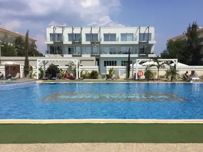 a large swimming pool in front of a building at Apartment Helena in Paralimni
