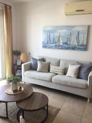 a living room with a couch with sails on the wall at Apartment Helena in Paralimni