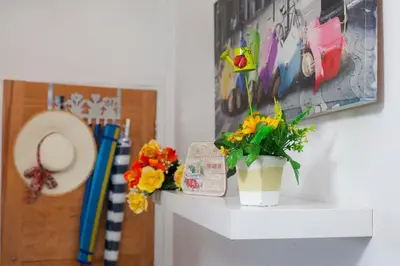 a white shelf with a potted plant on it at Artemis Boutique Apartment 1 in Limassol