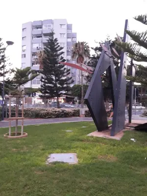 a metal sculpture in the grass in a park at Artemis Boutique Apartment 1 in Limassol
