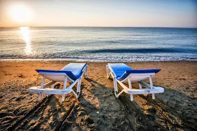two blue and white chairs on the beach at Artemis Boutique Apartment 1 in Limassol