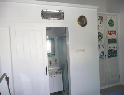 a bathroom with a white door and a sink at The Stable in Limassol