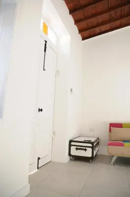 a living room with a couch and a door at The Stable in Limassol