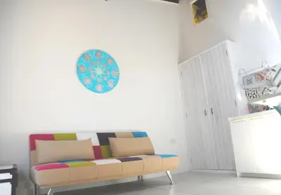 a living room with a couch and a plate on the wall at The Stable in Limassol