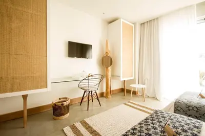a room with a bed and a chair and a television at Aelia Wellness Retreat in Nicosia