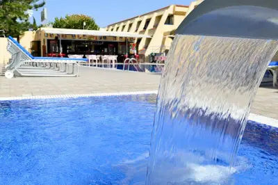 a water fountain in the middle of a swimming pool at Napa Prince Hotel Apts in Ayia Napa