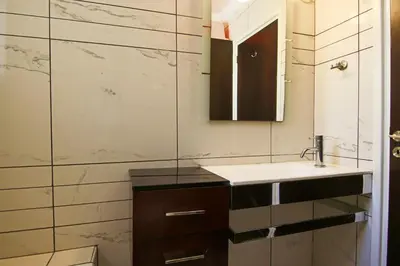 a bathroom with a sink and a mirror at Seaside Luxury Flat Pervolia in Pervolia