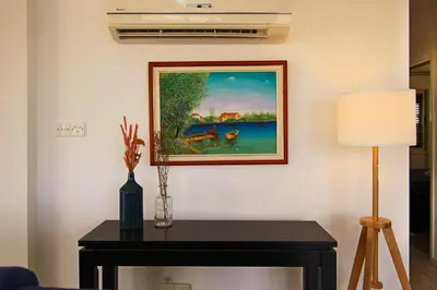 a painting on a wall next to a table with a lamp at Seaside Luxury Flat Pervolia in Pervolia
