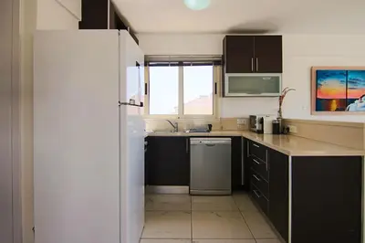 a small kitchen with a sink and a refrigerator at Seaside Luxury Flat Pervolia in Pervolia