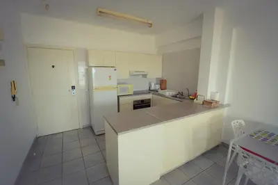 a kitchen with a white refrigerator and a counter top at Krasas Beach Flats in Larnaka