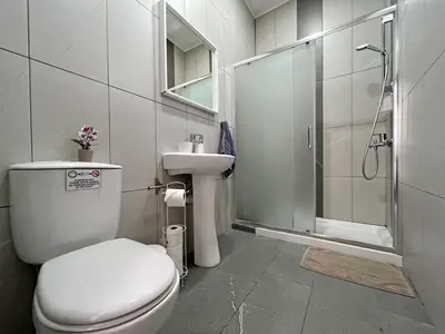 a bathroom with a toilet and a sink and a shower at Apollo Rooms by Albert's Apartment in Larnaka