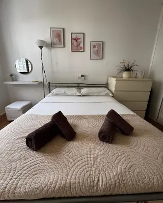 a bedroom with a bed with two pillows on it at Theodoros Apt. 408 in Protaras