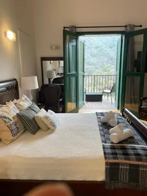 a bedroom with a bed with towels on it at Theoxenia in Kalopanayiotis