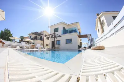 a swimming pool in front of a villa at Villa Alexandra in Ayia Napa