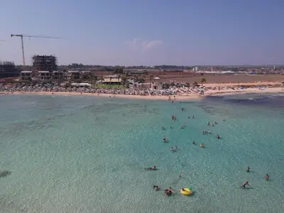 a group of people in the water at a beach at Villa Alexandra in Ayia Napa